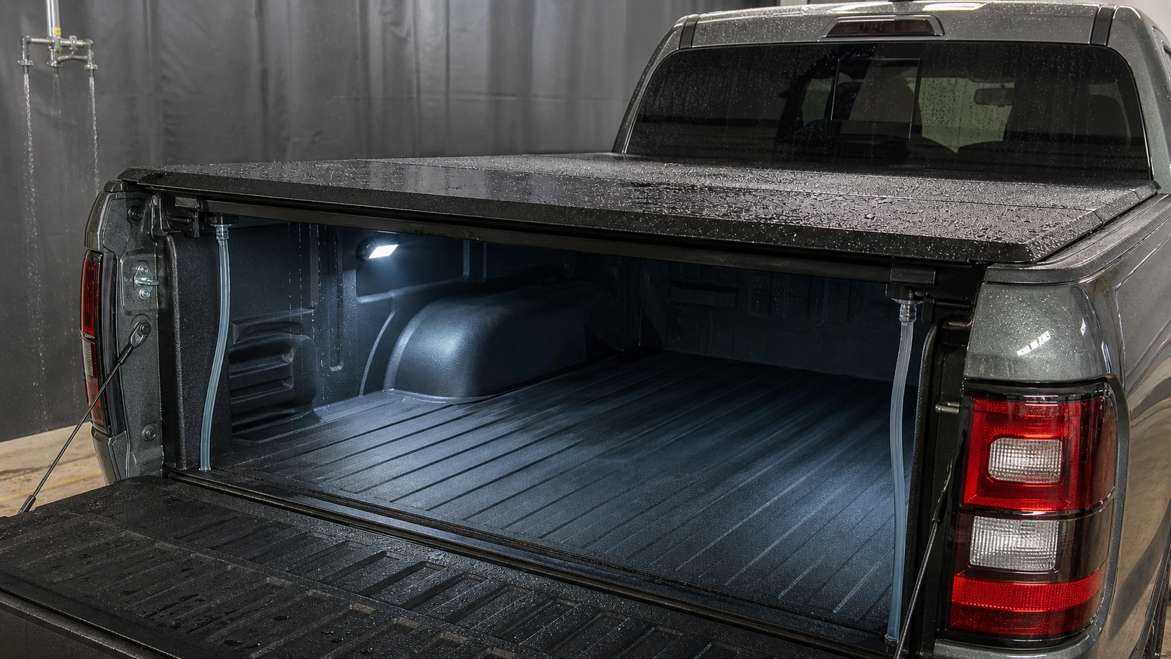 Controlled water-routing test on a hard tonneau cover with the tailgate open