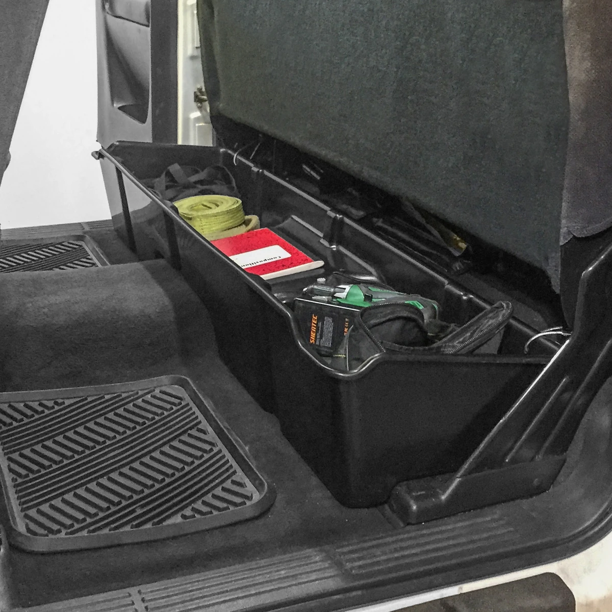 Molded Red Hound under-seat storage organizer for a pickup rear cab