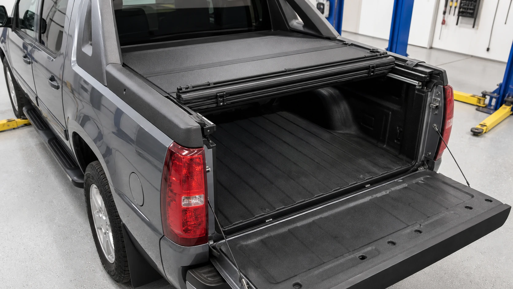 Partially folded hard tonneau cover showing Avalanche bed rails and cargo access