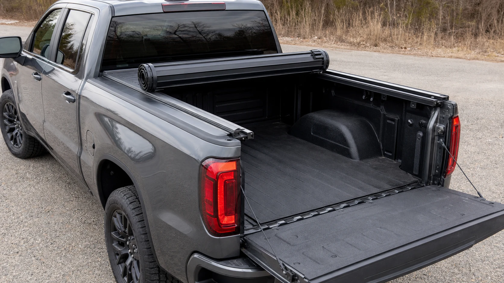 Hard-rolling pickup tonneau cover rolled toward the cab with the bed open